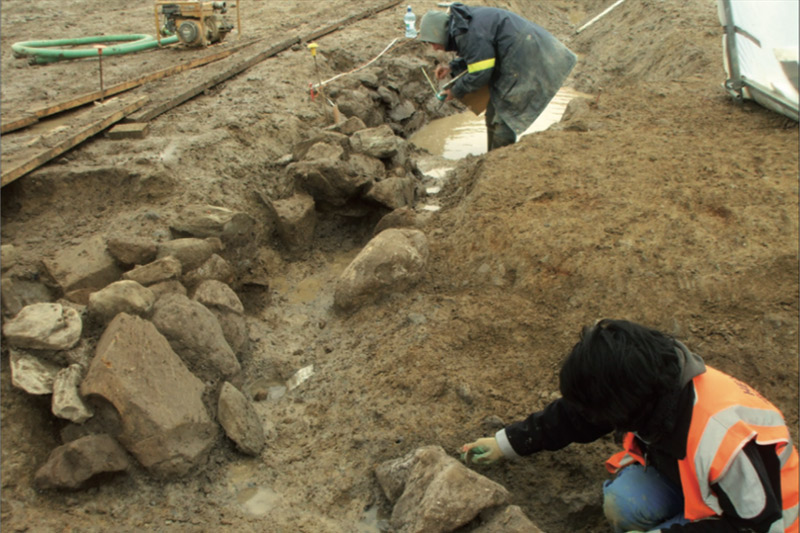 Stone lined medieval ditch under excavation