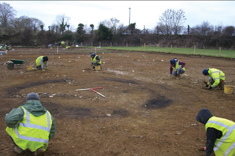 The site at Ballinorig West 4. Excavation in progress around the Iron Age ring-ditch and associated cremation burials, with the ditch fills still in situ, view to north-west. This site was excavated during works on the N22 Tralee Bypass