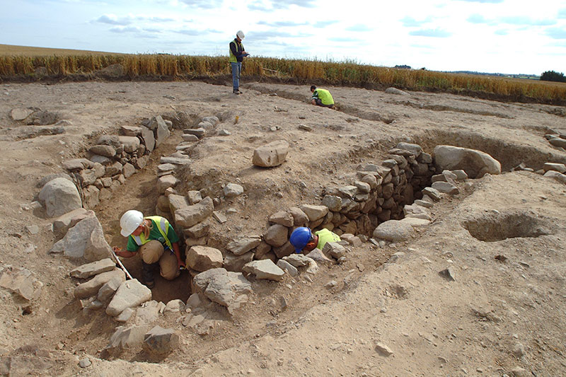 Archaeological excavation during the M1 Dundalk Bypass at Carn More 1. A previously unrecorded ringfort was entirely levelled over the centuries by tillage, but a souterrain in the interior survived (StudioLab)