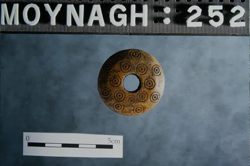 Decorated bone spindle whorl from Moynagh Lough (photograph by Albert Glaholm, 1995)